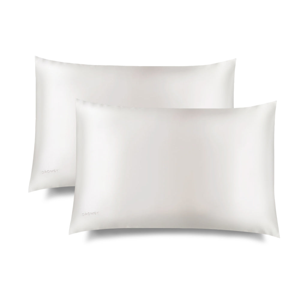 Two Rajah Cushion Covers by drowsysleepco are displayed on a white background, with one slightly overlapping the other. The fabric of these white rectangular covers appears smooth and shiny.