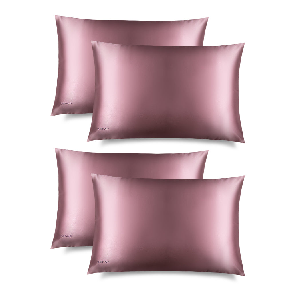 Four Damask Rose Silk Pillowcases by drowsysleepco are arranged in two rows on a white background. Each smooth, shiny case features a small logo and offers hair protection and skincare benefits while you sleep.