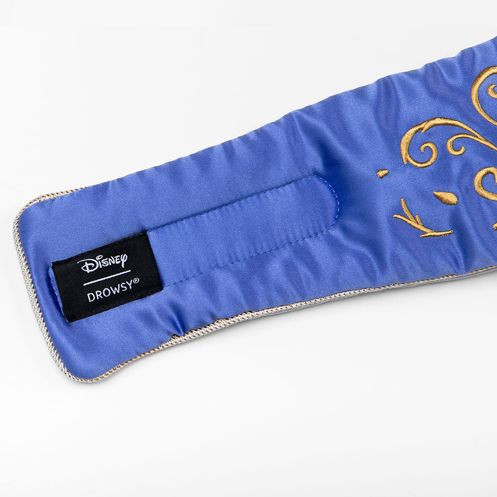 The drowsysleepco Magic Carpet Sleep Mask is a luxurious blue satin eye mask featuring gold embroidery and an inner Disney Drowsy label, crafted from elegant mulberry silk for peaceful sleep.