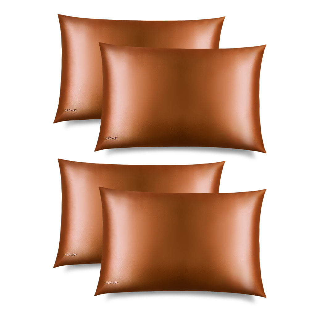 Four Pumpkin Spice Silk Pillowcases by drowsysleepco are arranged in two rows on a white background. Each hair-protecting pillowcase has a small black logo, helping reduce sleep creases and keep your hair smooth.