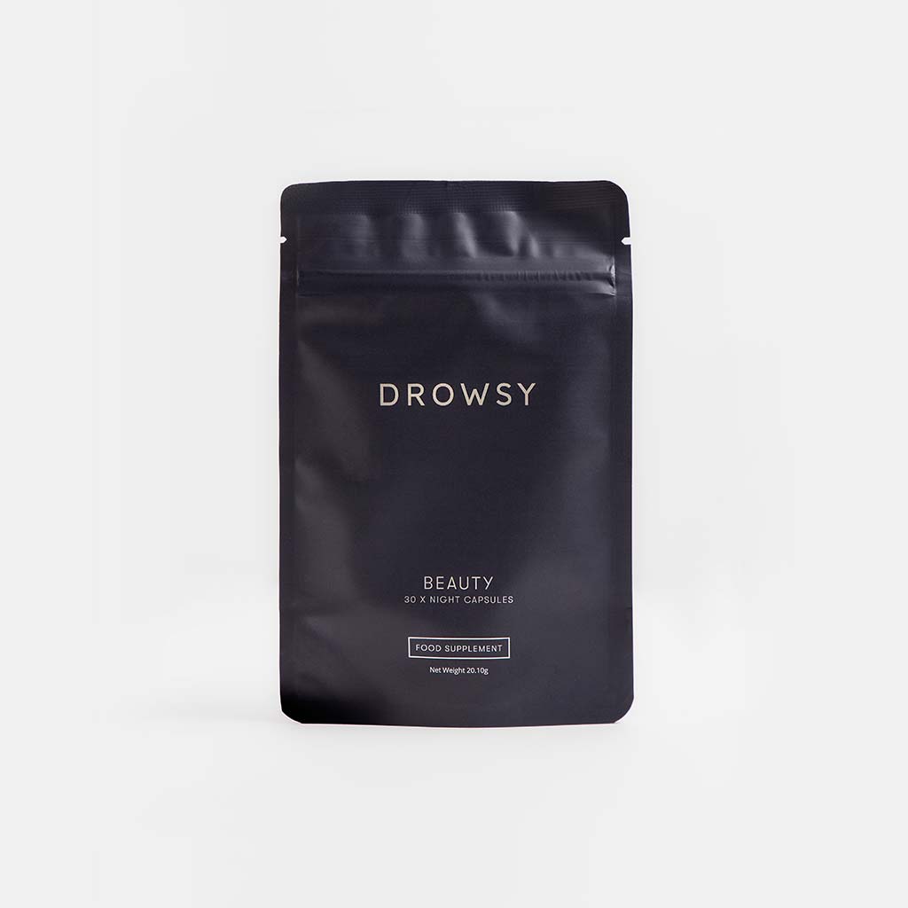 A black resealable pouch labeled drowsysleepco Beauty Supplement Subscription contains 30 night capsules. The minimalistic packaging features simple white text on a plain, light background.