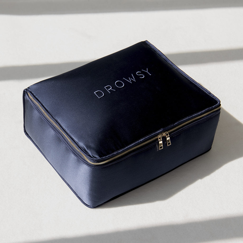 A midnight blue rectangular weighted silk blanket from drowsysleepco is displayed on a light surface with soft shadows—ideal for deep relaxation and restful sleep.