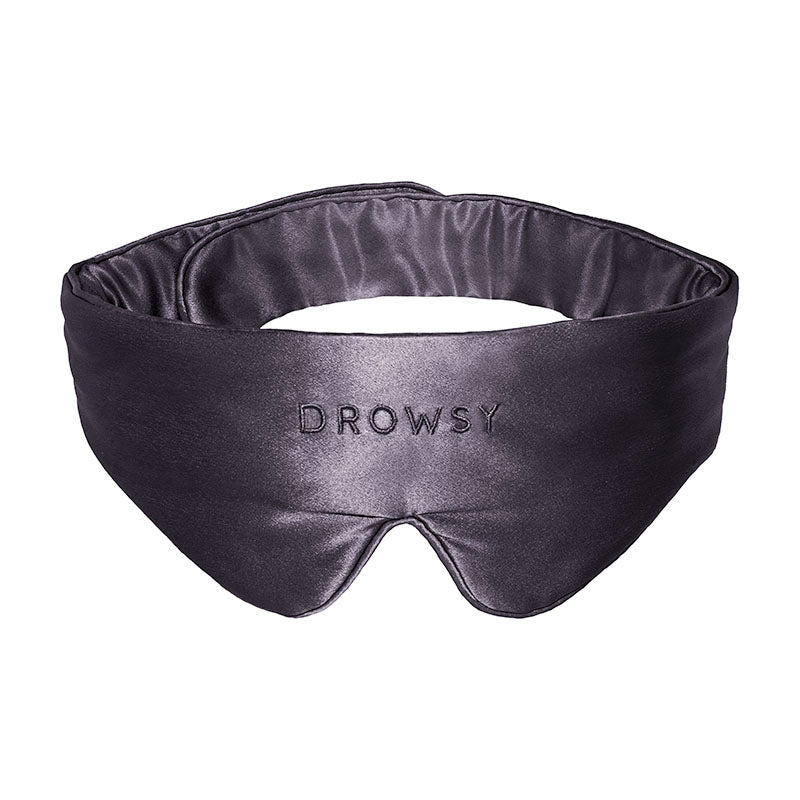 Introducing the Moonlight Shadow Featherweight Silk Sleep Mask by drowsysleepco, a luxurious blackout eye mask crafted from black mulberry silk. This silky sleep mask features the drowsysleepco logo elegantly embroidered on the front and is showcased against a crisp white background.