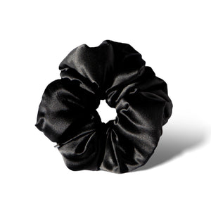 The Black Jade - Padded Scrunchie by drowsysleepco is an oversized black satin accessory, pictured on a white background with a soft shadow—designed to protect hair and elevate your style.