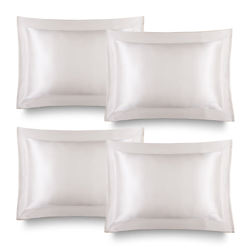 Four Hyalo Pillowcases – Akoya Pearl by us.drowsysleepco are neatly arranged in two rows of two against a plain white background. Each pillowcase features a smooth, shiny silk finish and an elegant, crisp border, designed to promote overnight hydration for healthier-looking skin.