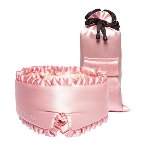 The drowsysleepco Sleep and the City Powder Pink Sleep Mask, featuring ruffled edges and “DROWSY” embroidery, is shown with a matching satin pouch tied with a black ribbon—perfect for ultimate beauty sleep.