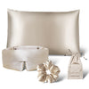 The drowsysleepco Sensual Sleep Bundle in Dusty Gold features a silk pillowcase, sleep mask, scrunchie, and drawstring pouch, all beautifully arranged on a white background.