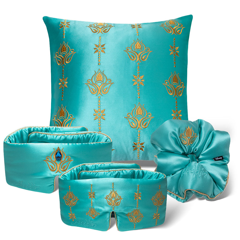 The Jasmine Bundle by drowsysleepco features turquoise silk accessories with gold patterns—a decorative pillow, eye mask, headband, and scrunchie—stylishly arranged against a white background.