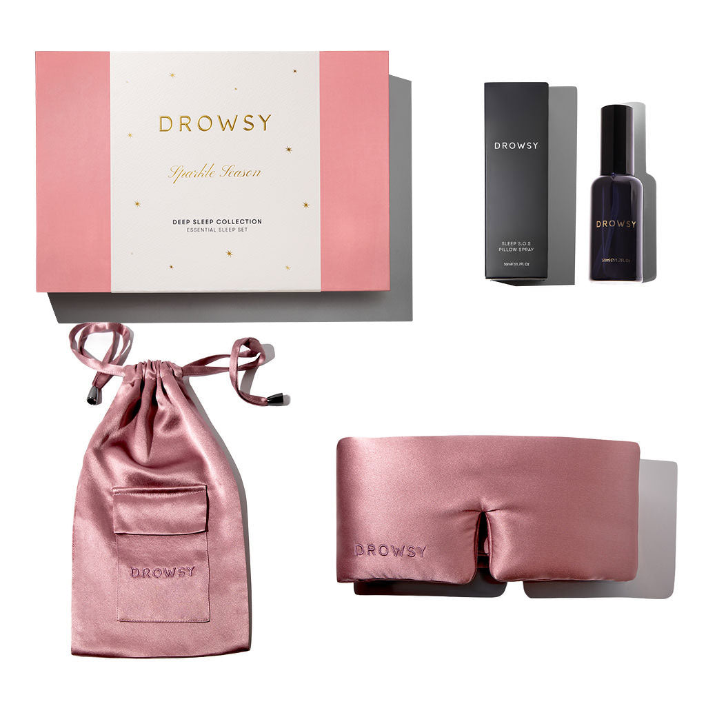 The Damask Rose Deep Sleep Collection by drowsysleepco features a luxury silk sleep mask, pink silk carry pouch, branded box, and deep sleep pillow spray, all arranged neatly on a white background.