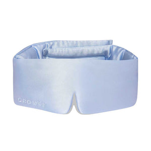 The Blue Belle silk sleep mask by drowsysleepco features DROWSY embroidery on the side. Shown here in light blue, this blackout eye mask is set against a white background.