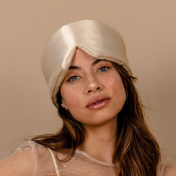 Model with Drowsy beige coloured silk sleep mask on her head