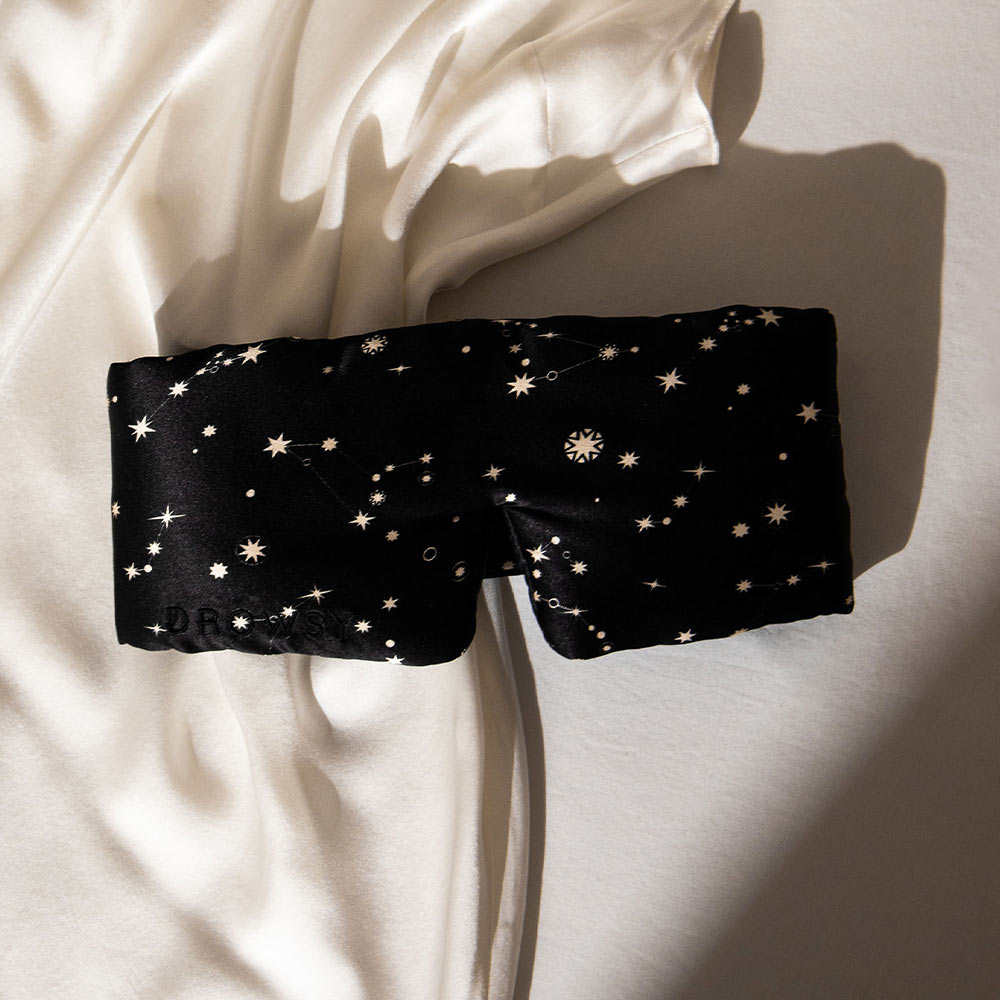 Starry patterned sleep mask on white silk