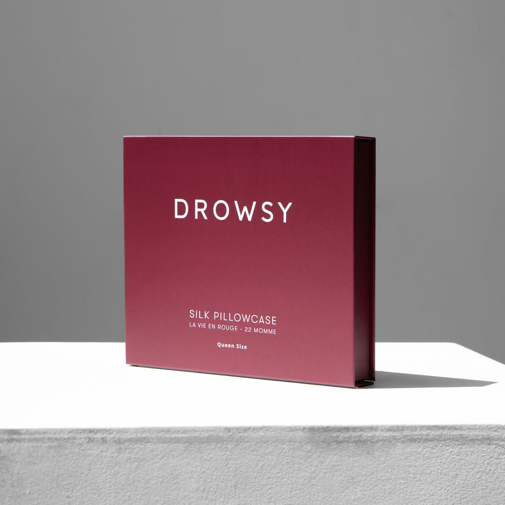 Rouge coloured Drowsy silk pillowcase box on a white background
