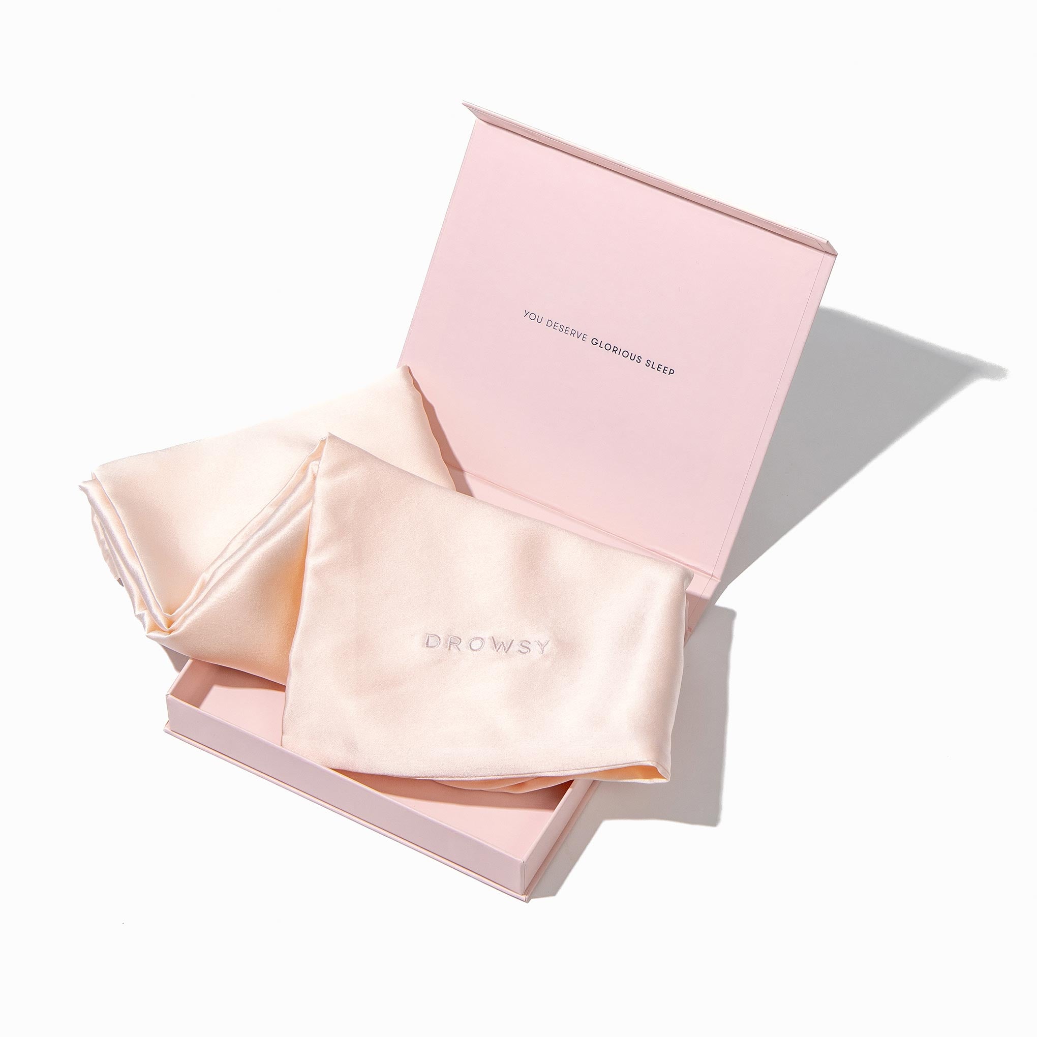 Baby pink pillowcase box opening with baby pink silk pillowcase inside