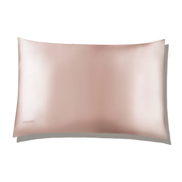 Pastel pink coloured Drowsy silk pillowcase on a white background