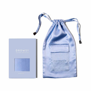 A light blue mulberry silk pouch with a drawstring sits next to a matching box labeled Blue Belle Silk Carry Pouch by drowsysleepco, both displayed on a white background.