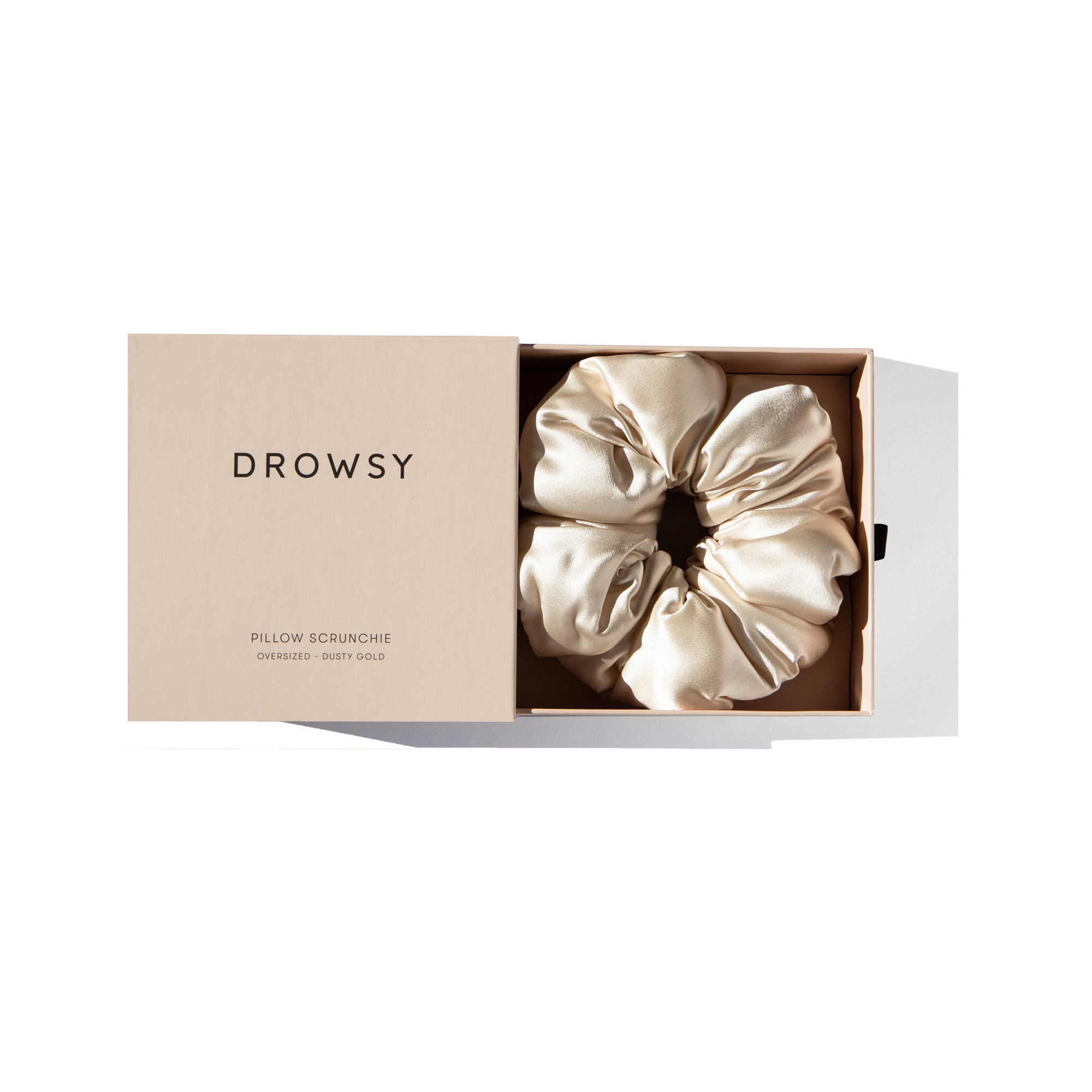 Drowsy Dusty Gold Pillow Scrunchie in its box on a white background