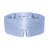 Model wearing baby blue coloured silk sleep mask in the sunlight with a white background