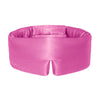 A woman in a light tank top stands outdoors against a blue sky, smiling slightly as she adjusts the us.drowsysleepco Hotel Paradiso Heatwave Sleep Mask.