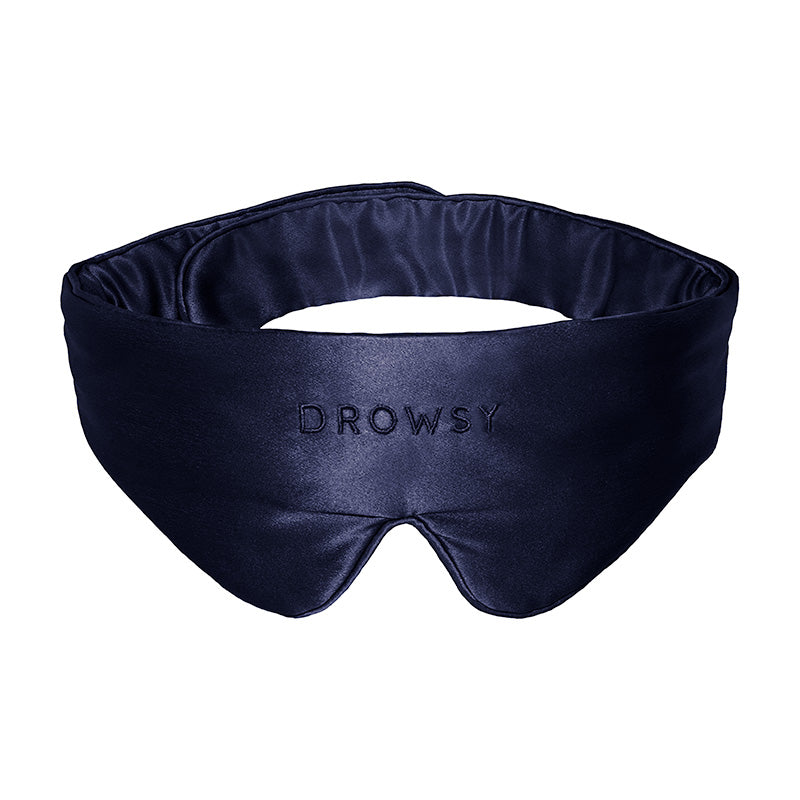 Introducing the Midnight Blue Featherweight Silk Sleep Mask from drowsysleepco—a luxurious, dark blue mulberry silk eye mask expertly padded and contoured for superior comfort and exceptional light blocking. The word "DROWSY" is elegantly embroidered on the front.