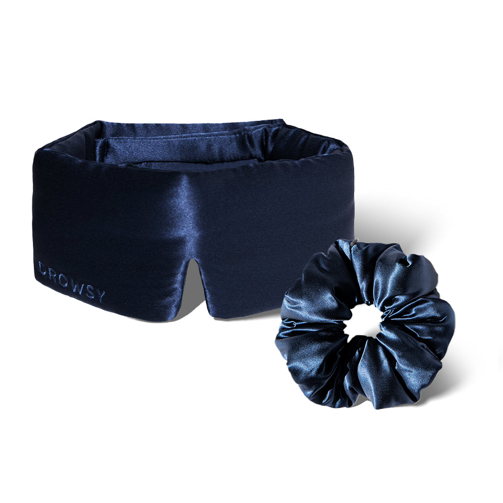 The Silky Skin & Hair Bundle – Midnight Blue by drowsysleepco features a luxurious dark blue silk sleep mask with DROWSY embroidery and a matching silk scrunchie, displayed together on a white background.