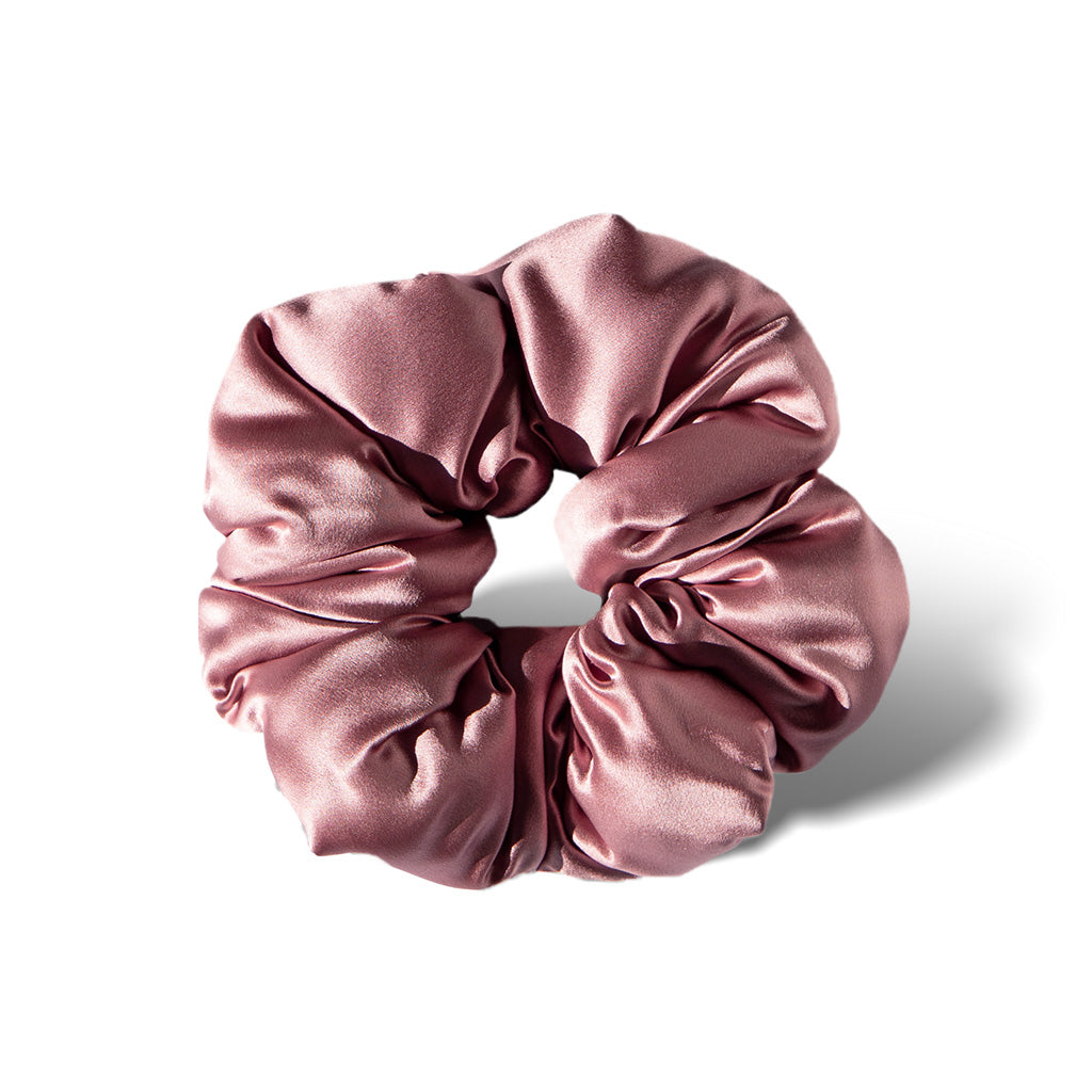 The drowsysleepco Damask Rose - Padded Scrunchie is a shiny, silky pink oversized hair accessory with a smooth texture, shown in a circular shape on a white background—ideal for comfortable sleep.
