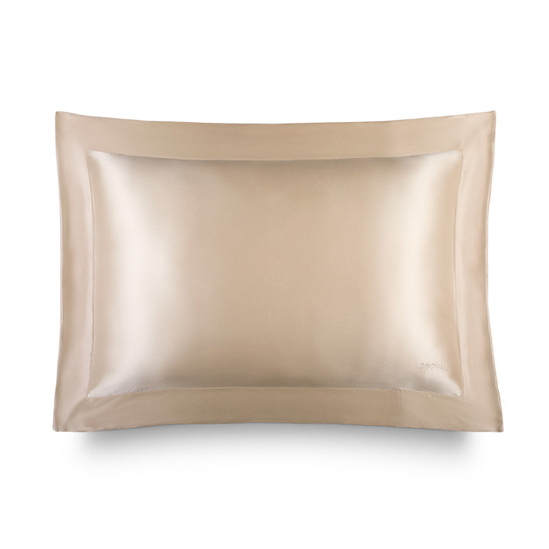The Hyalo Pillowcase in Champagne Gold by us.drowsysleepco features a smooth, lustrous silk texture and is displayed against a white background. Designed with a wide border and a subtle embroidered logo in one corner, this pillowcase delivers luxurious overnight hydration and exceptional comfort.