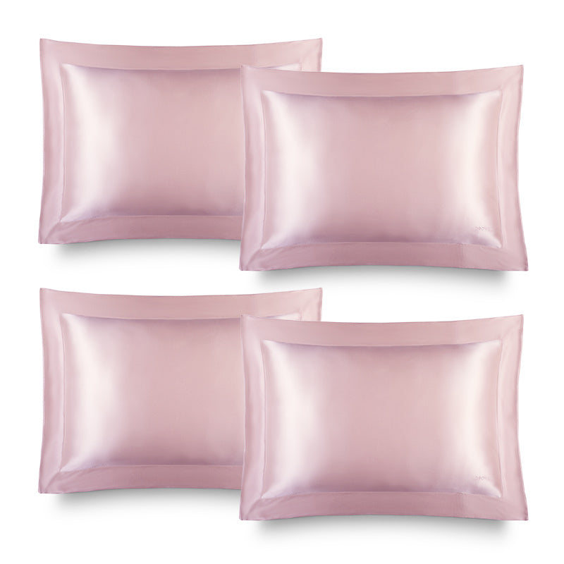 Four lustrous Hyalo Pillowcase - Petal Pink pillowcases from us.drowsysleepco are neatly arranged in two rows on a white background, offering the ideal setting for overnight hydration and a luxurious experience inspired by the benefits of silk pillowcases.