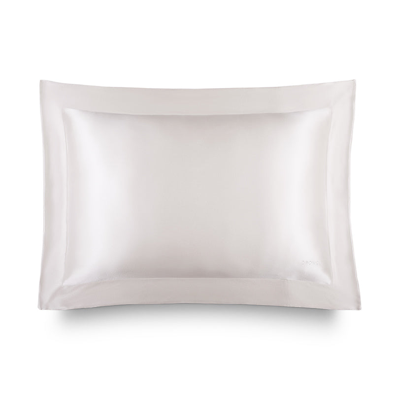 The Hyalo Pillowcase - Akoya Pearl by us.drowsysleepco features a smooth, lustrous white silk finish and a wide stitched border, shown against a plain white background. It offers overnight hydration to help keep your skin looking fresh and radiant.