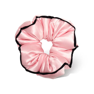 The drowsysleepco Sleep and the City - Pink Padded Scrunchie features shiny pink satin with black trim, shown against a white background.