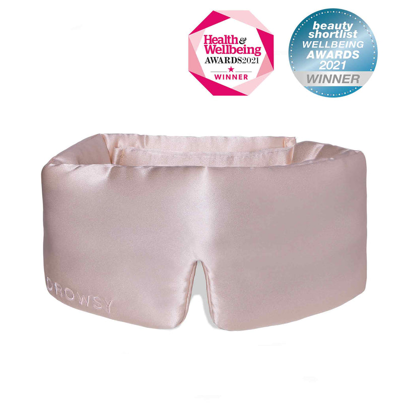 Luxury sunset pink Drowsy silk sleep mask on white background with beauty awards